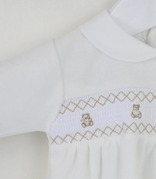 Flat lay of ivory velour baby outfit with teddy smocking and Peter Pan collar
