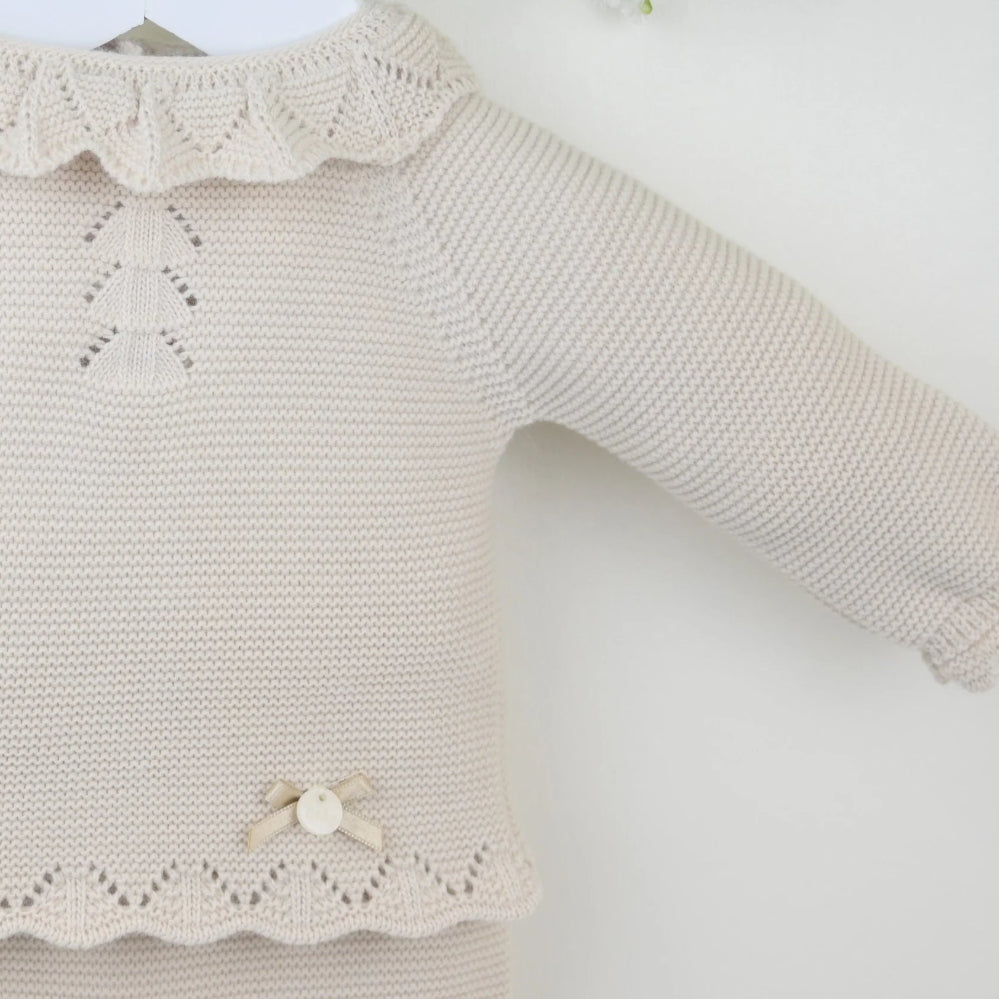 Pink 3-piece knitted baby outfit by Pex with bonnet, frill collar, and footed trousers – also available in white and beige