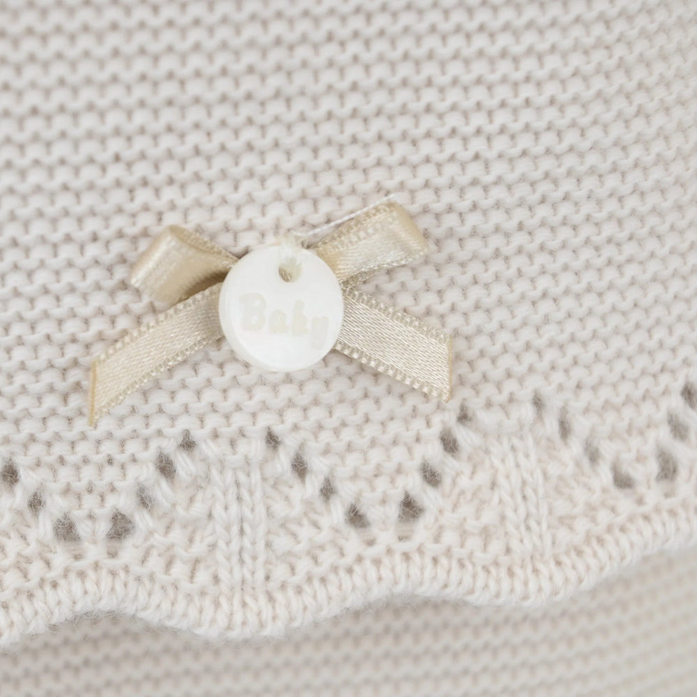 Pink 3-piece knitted baby outfit by Pex with bonnet, frill collar, and footed trousers – also available in white and beige
