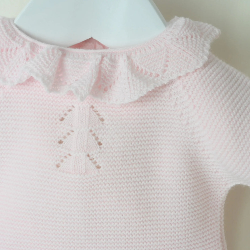 Pink 3-piece knitted baby outfit by Pex with bonnet, frill collar, and footed trousers – also available in white and beige