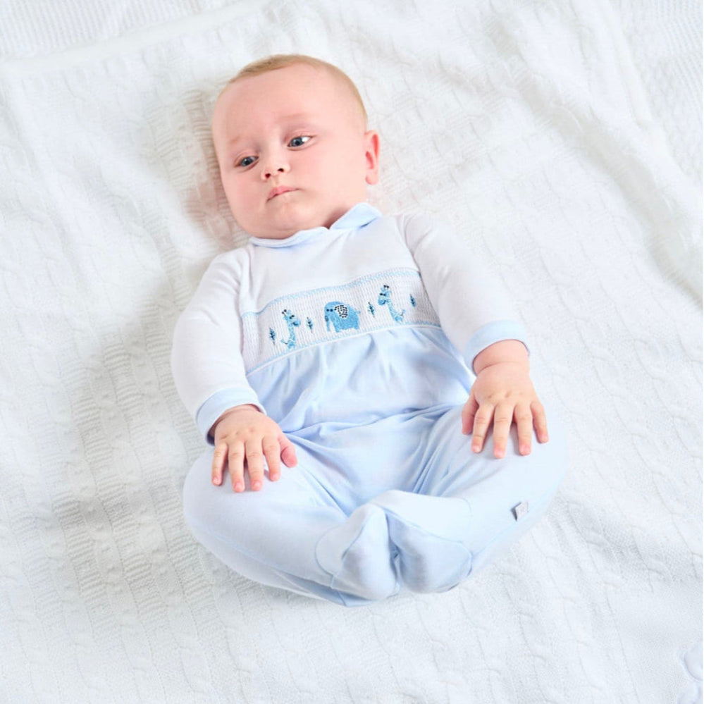 Dandelion Jungle Friends smocked cotton baby onesie with jungle animal appliqués and Peter Pan collar, shown in pale blue