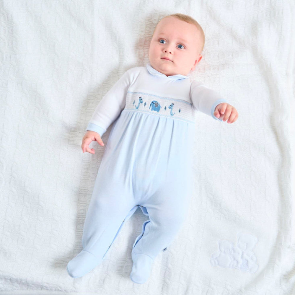 Dandelion Jungle Friends smocked cotton baby onesie with jungle animal appliqués and Peter Pan collar, shown in pale blue