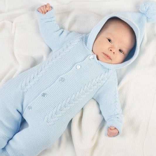 Sky blue knitted baby pramsuit with bobble hood by Dandelion – front view on hanger