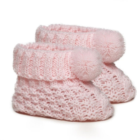 Pink knitted baby booties with soft pom pom detail – newborn size