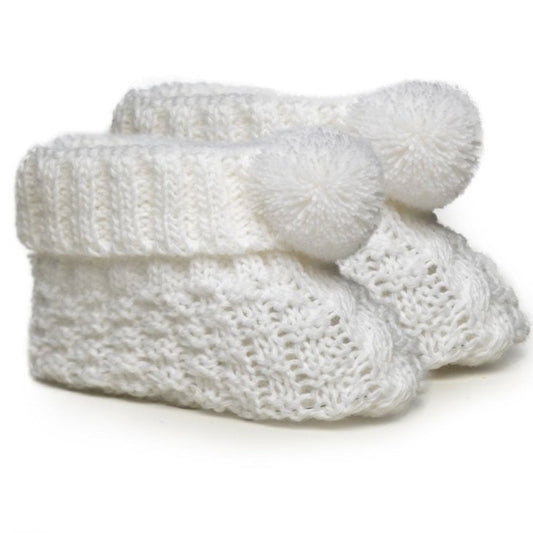 White knitted baby booties with pom pom detailing – newborn size